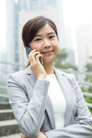 Business woman talk to cellphoneの写真素材