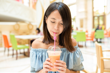 Woman having drinkの写真素材