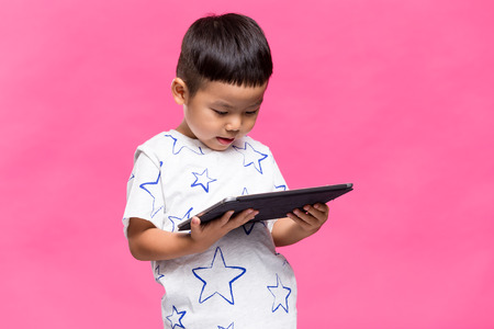 Little boy looking on tablet computerの写真素材
