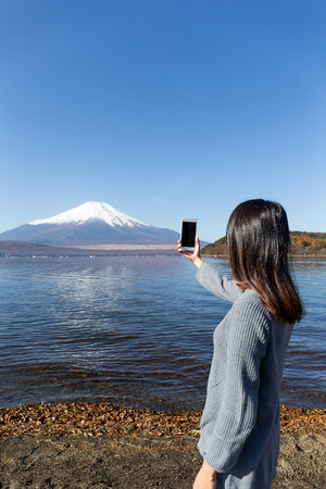 Woman take photo of Fujisanの写真素材