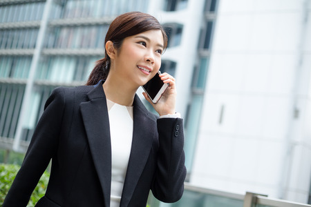 Businesswoman talk to mobile phoneの写真素材