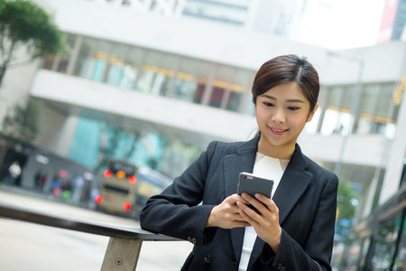 Young Businesswoman reading on cellphoneの写真素材