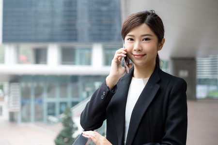 Asian business woman talk to mobile phoneの写真素材