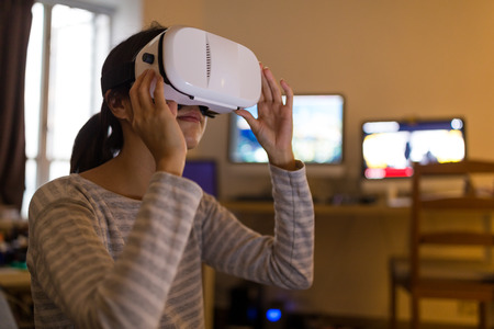 Woman wearing VR deviceの写真素材