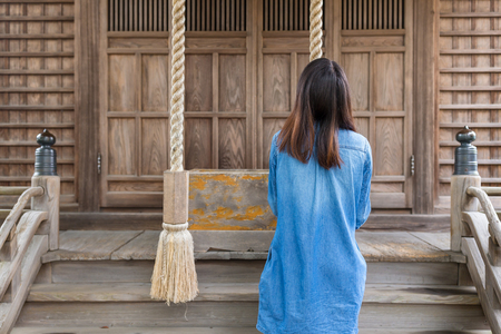 Back rear view of woman wishing a hopeの写真素材