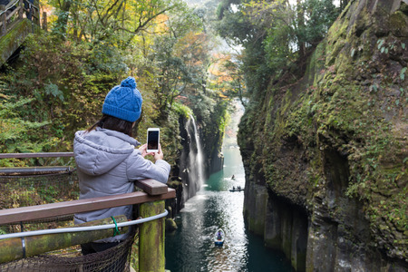 Woman taking photo in Takachiho gorgeの写真素材