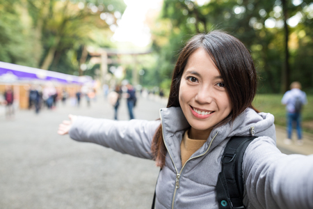 Woman taking photo by digital cameraの写真素材