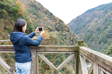 Woman taking photo with cellphoneの写真素材
