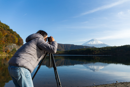 Woman taking photo on Mount Fujiの写真素材