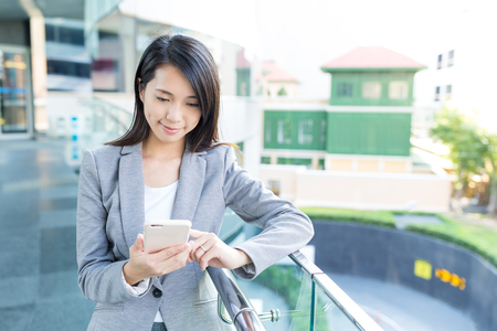 Businesswoman use of mobile phoneの写真素材