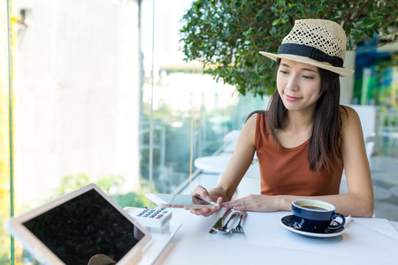 Woman checkout by paying on mobile phone, NFC payment conceptの写真素材