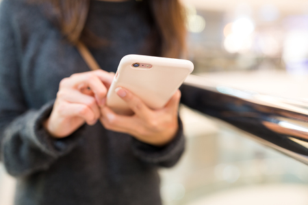 Woman sending text message on mobile phoneの写真素材