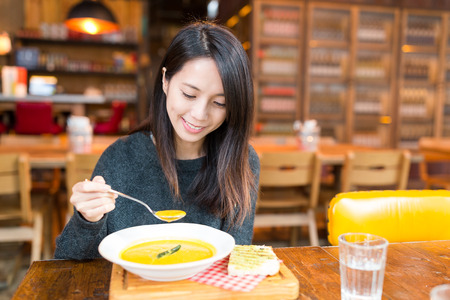 Woman enjoy her meal at restaurantの写真素材