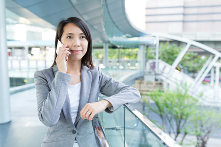 Businesswoman talk to mobile phoneの写真素材