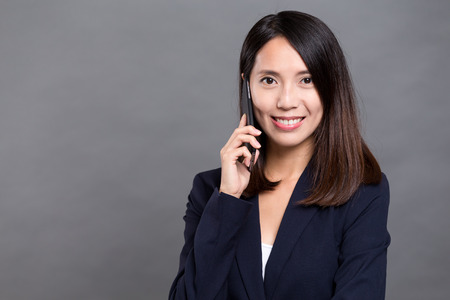 Businesswoman talk to mobile phoneの写真素材