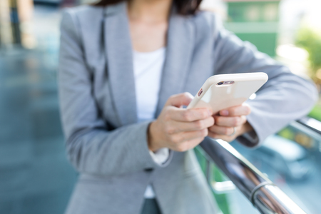 Businesswoman working on cellphoneの写真素材