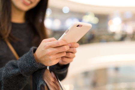 Woman working on mobile phoneの写真素材