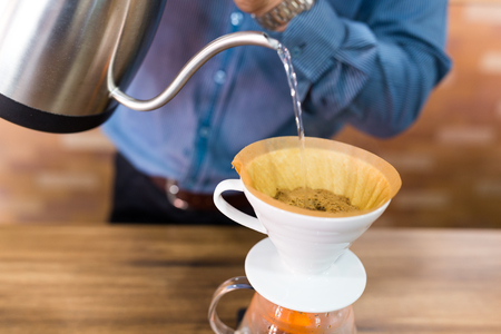 Barista Pouring water on coffee filterの写真素材