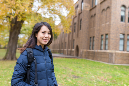 Young student at school in autumn seasonの写真素材