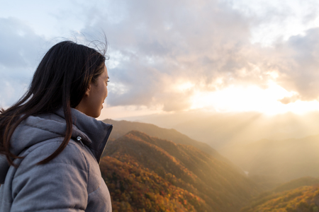 Woman looking Mount Hangetsuyama during sunsetの写真素材