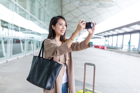 Woman taking photo in Hong Kong international airportの写真素材
