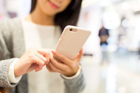 Woman working on cellphoneの写真素材