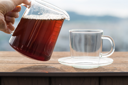 Pouring coffee into a glassの写真素材