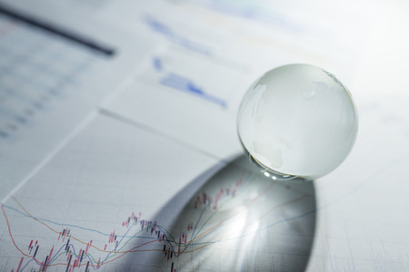 Glass globe on stock market chartの写真素材