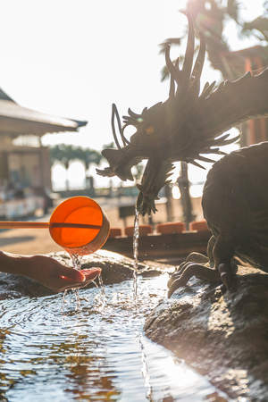 Bamboo fountain and dragon under sunlightの写真素材