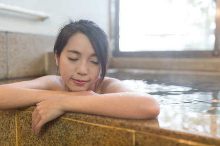Woman enjoy hot bath indoorの写真素材