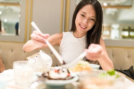 Woman enjoy dinner in restaurantの写真素材