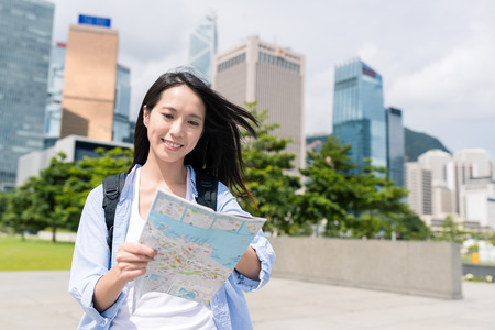 Young woman use of map in Hong Kongの写真素材