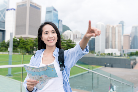Woman using city map in Hong Kongの写真素材