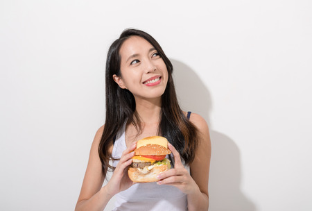 Woman happy with burgerの写真素材