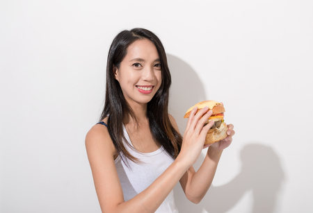 Woman having burgerの写真素材
