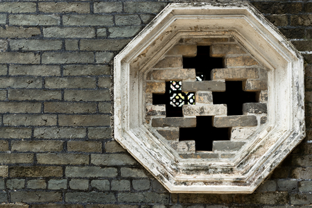 Chinese window on brick wallの写真素材