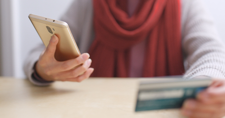 Woman having online shopping on cellphone and credit card の写真素材
