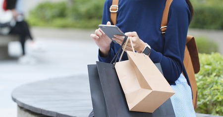 Young woman use of mobile phone at outdoor の写真素材