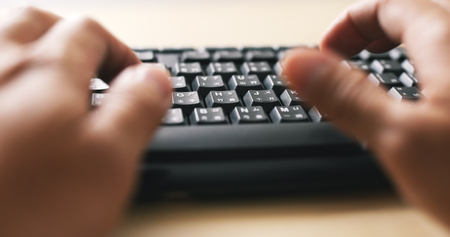 Man hands typing on a computer keyboard の写真素材