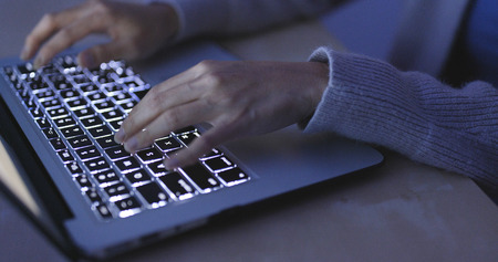 Woman use of laptop computer at night 