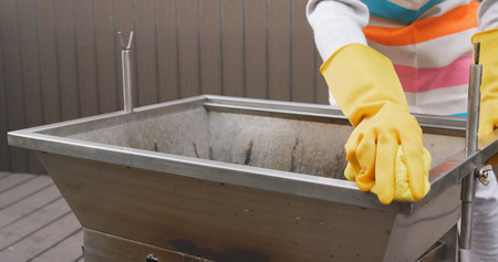 Cleaning of barbecue oven at outdoor の写真素材