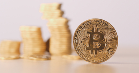 Bitcoin with pile of coin over the backの写真素材