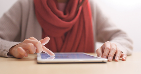 Woman touch on tablet computer on table の写真素材