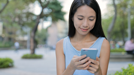 Woman using smart phone in the cityの写真素材