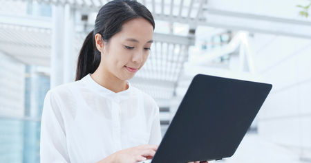 Asian businesswoman works on laptop computer の写真素材
