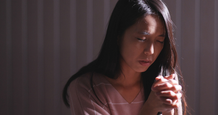 Woman pray in the dark の写真素材