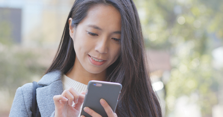 Business woman using smart phone at outdoor の写真素材