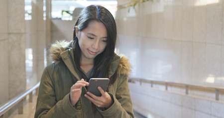 Woman use of mobile phone at outdoor の写真素材