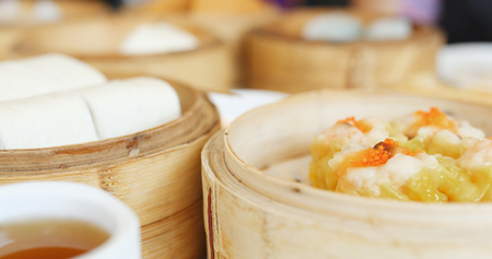Eating steamed chinese dim sum in restaurant の写真素材