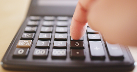 Counting on calculator の写真素材